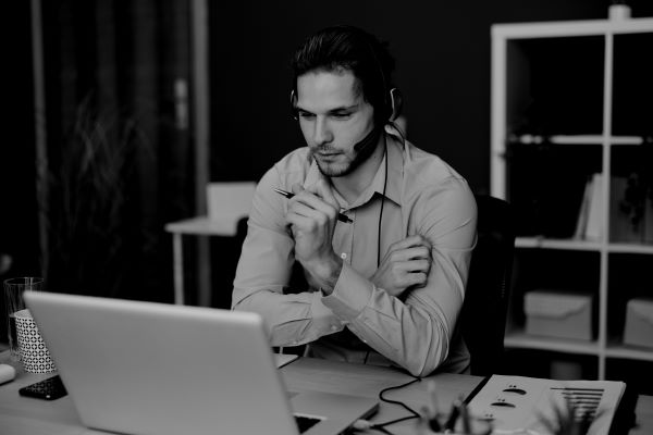 photo of a men sitting on a desc as symbol of CRM solutions